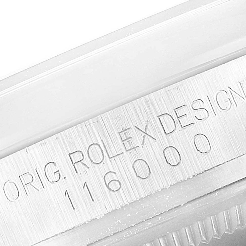 This close-up image shows the side of a Rolex Oyster Perpetual 116000 Men's Stainless Steel Grey Dial 116000 Men's Stainless Steel Grey Dial model watch, specifically the engraved model number and design details.