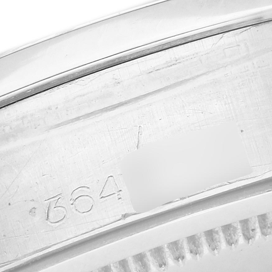 The image shows a close-up of the serial number engraving on the case of a Rolex Vintage Collection 6694 Men's Stainless Steel Black Dial 6694 Men's Stainless Steel Black Dial model.