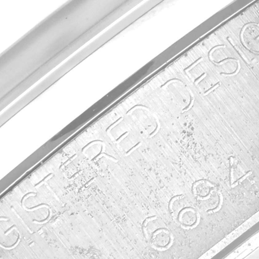 This close-up image shows the engraved text on the side of the case back of a Rolex Vintage Collection 6694 Men's Stainless Steel Silver Dial 6694 Men's Stainless Steel Silver Dial watch.