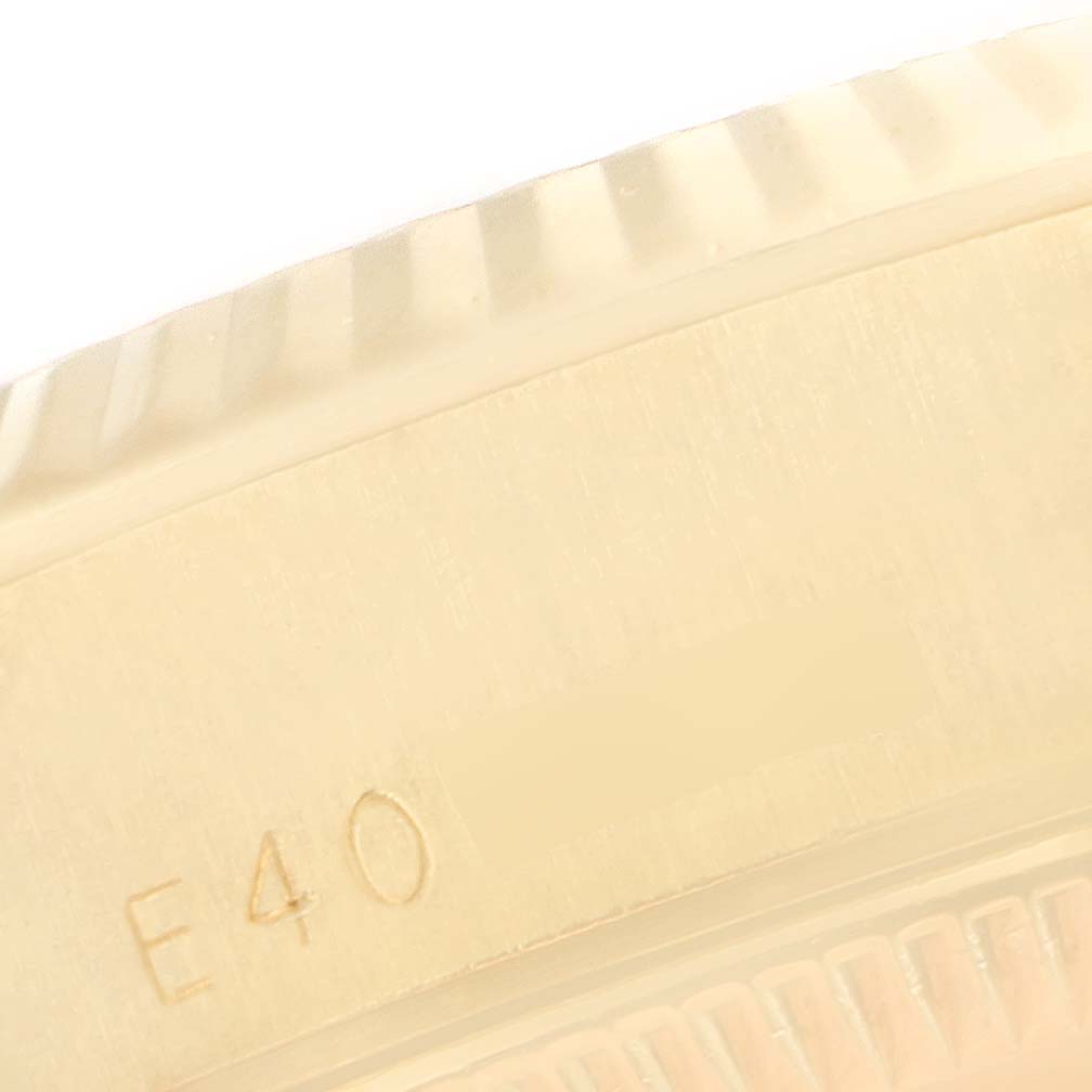 This image shows a close-up of the case side with part of the fluted bezel of a President model by Rolex.