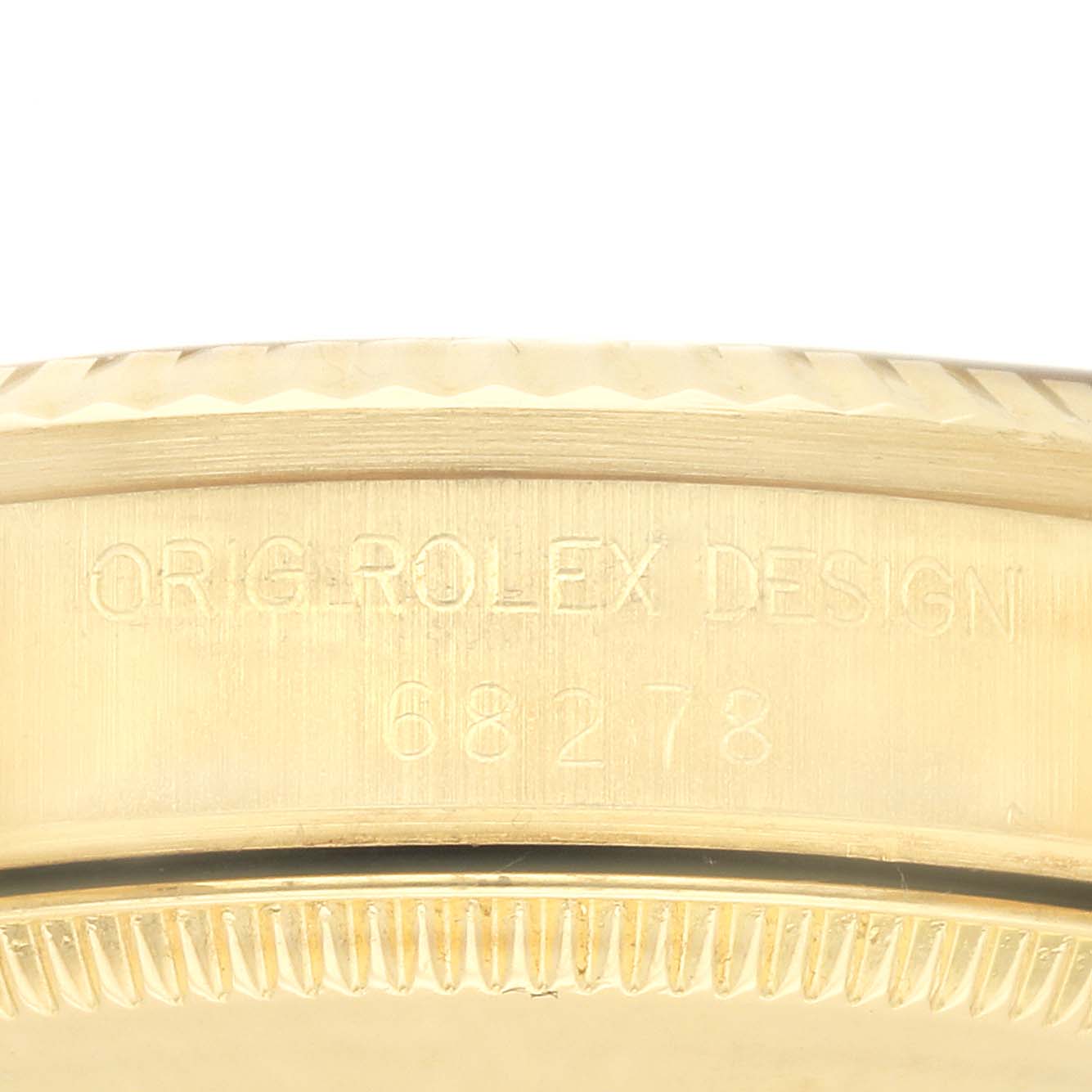 The image shows a close-up side view of the Rolex Mid-Size model
s bezel and case edge, displaying the engraved design number.