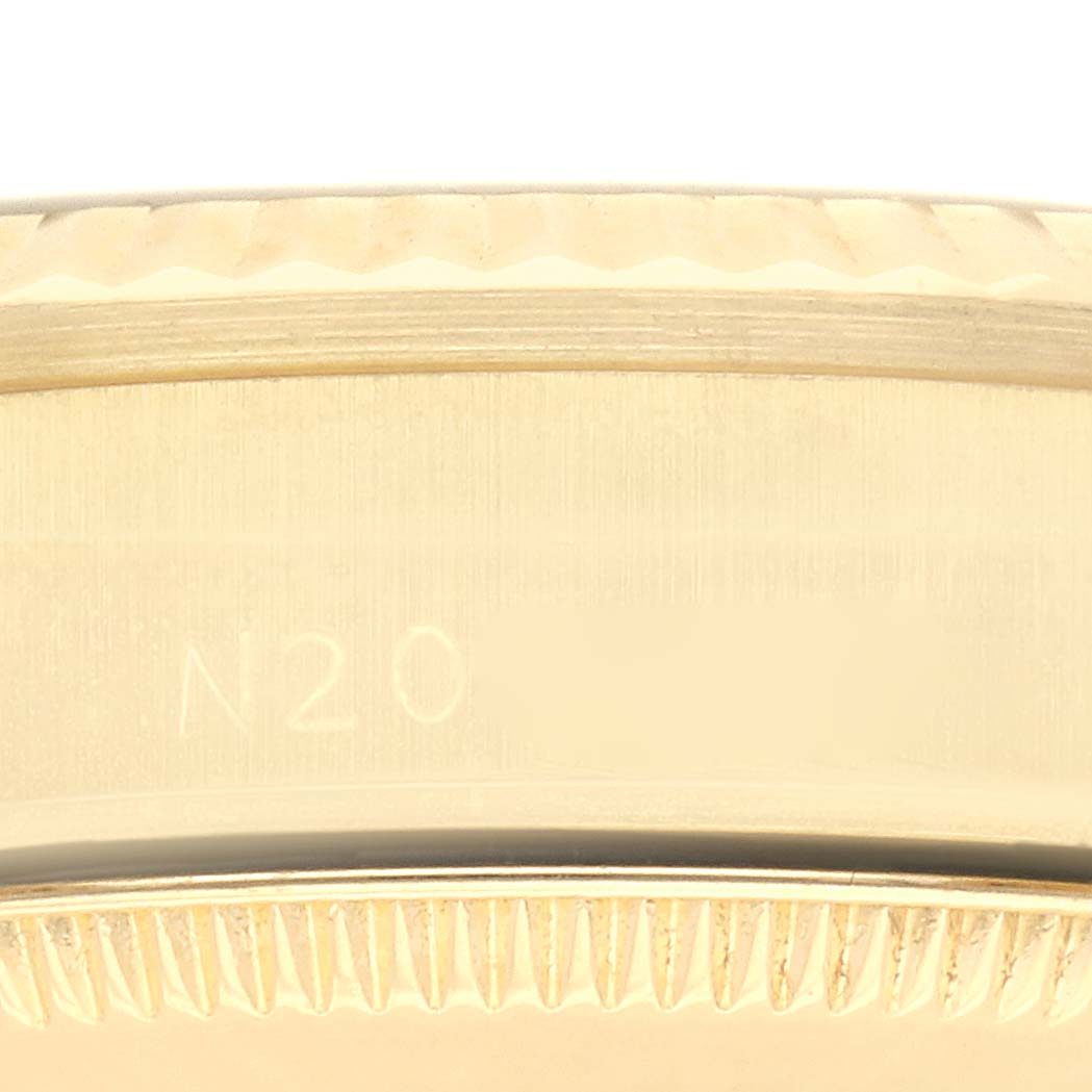 The image shows a close-up side view of the bezel and case edge of a Rolex Mid-Size watch.