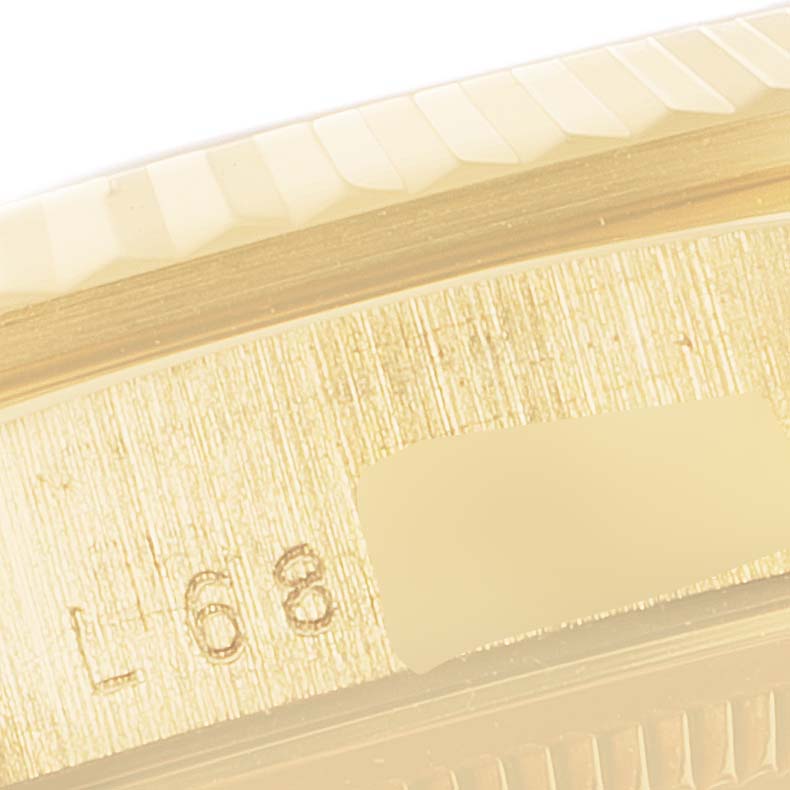 The image shows a close-up of the side engraving and edge of the bezel on a Rolex President 18238 Men's Yellow Gold Black Dial 18238 Men's Yellow Gold Black Dial model watch.