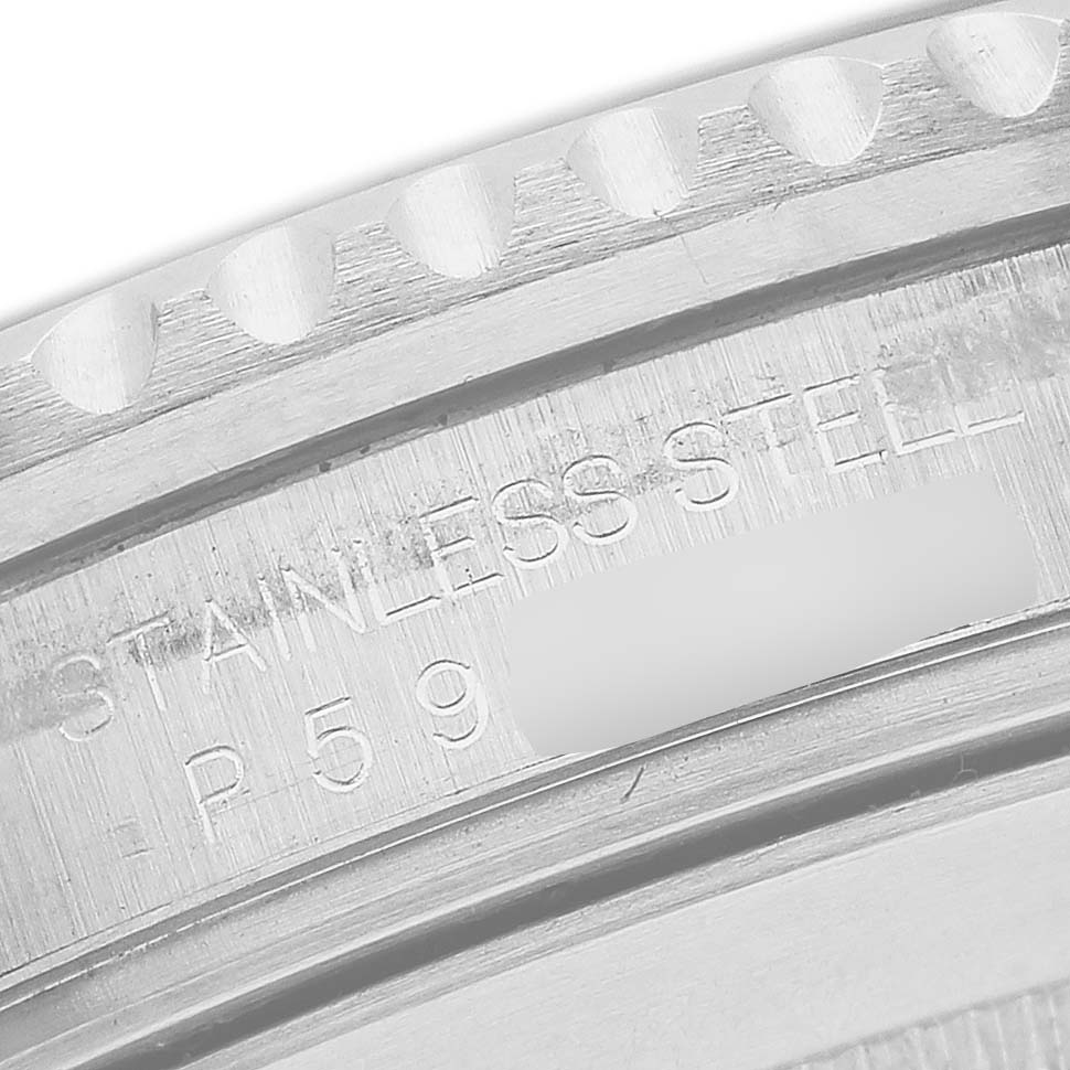 The image shows an engraved inner rim of a Rolex Submariner 16610 Men's Stainless Steel Black Dial watch case, highlighting the "STAINLESS STEEL" marking.