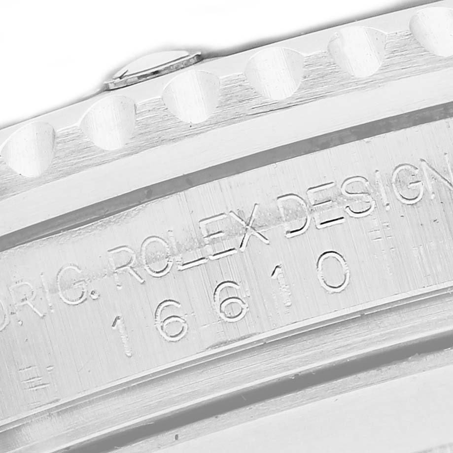 The image shows an angled close-up of the Rolex Submariner 16610 Men's Stainless Steel Black Dial's case with engraved model details.