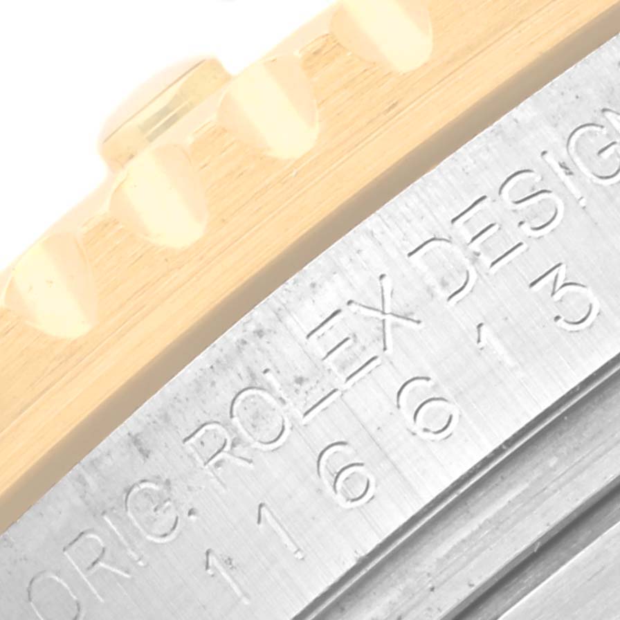 This image is a close-up of the bezel and engraved case side of a Rolex Submariner 116613LB Men's Steel and Gold (two tone) Blue Dial 116613LB Men's Steel and Gold (two tone) Blue Dial watch.