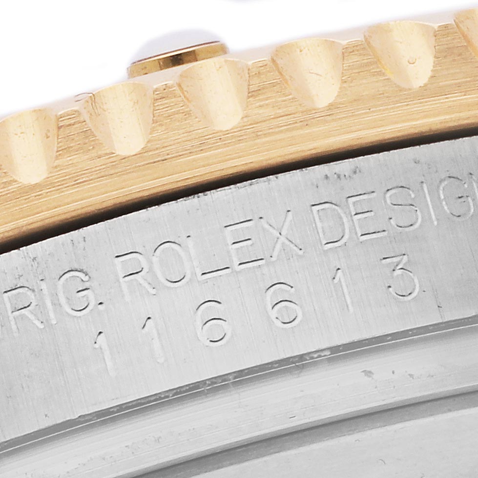 The image shows a close-up of the Rolex Submariner 116613LB Men's Steel and Gold (two tone) Blue Dial 116613LB Men's Steel and Gold (two tone) Blue Dial's engraved case side and bezel teeth.