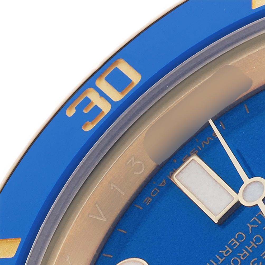 The image shows a close-up of the bezel and dial of a Rolex Submariner 116618LB Men's Yellow Gold Blue Dial 116618LB Men's Yellow Gold Blue Dial, highlighting the blue color and minute markers.