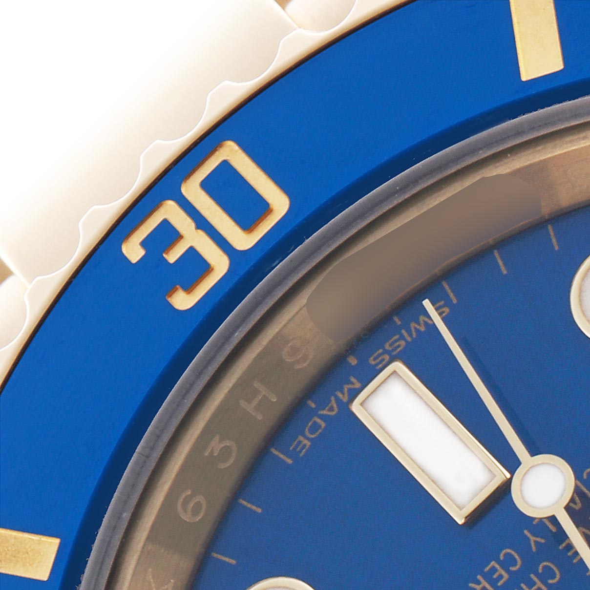 The image shows a close-up of the watch face of a Rolex Submariner 116618LB Men's Yellow Gold Blue Dial 116618LB Men's Yellow Gold Blue Dial, focusing on the blue bezel and dial with part of the minute hand visible.