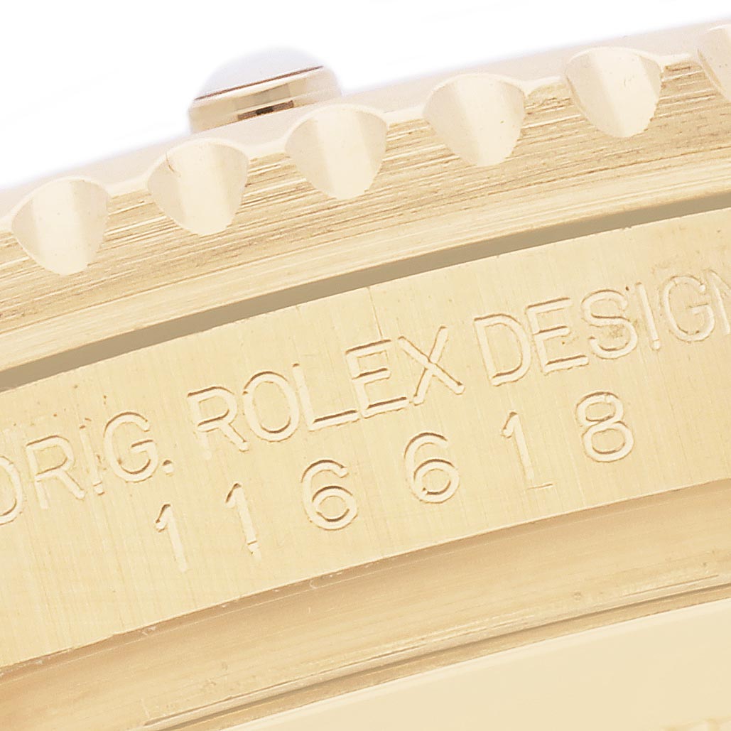 The image shows a close-up of the bezel and case sides, highlighting engravings on the Rolex Submariner 116618LB Men's Yellow Gold Blue Dial 116618LB Men's Yellow Gold Blue Dial.