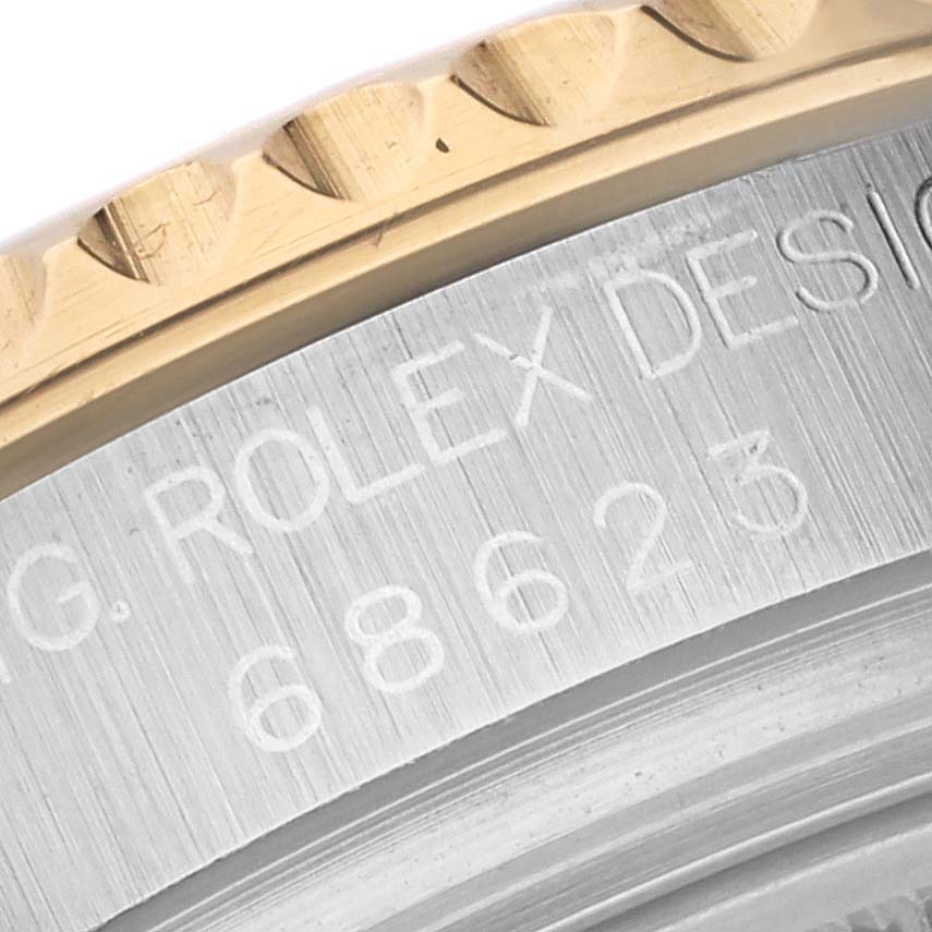 The image shows a close-up of the bezel and partially engraved case of a Rolex Yacht-Master 68623 Men's Steel and Gold (two tone) Grey Dial 68623 Men's Steel and Gold (two tone) Grey Dial watch.