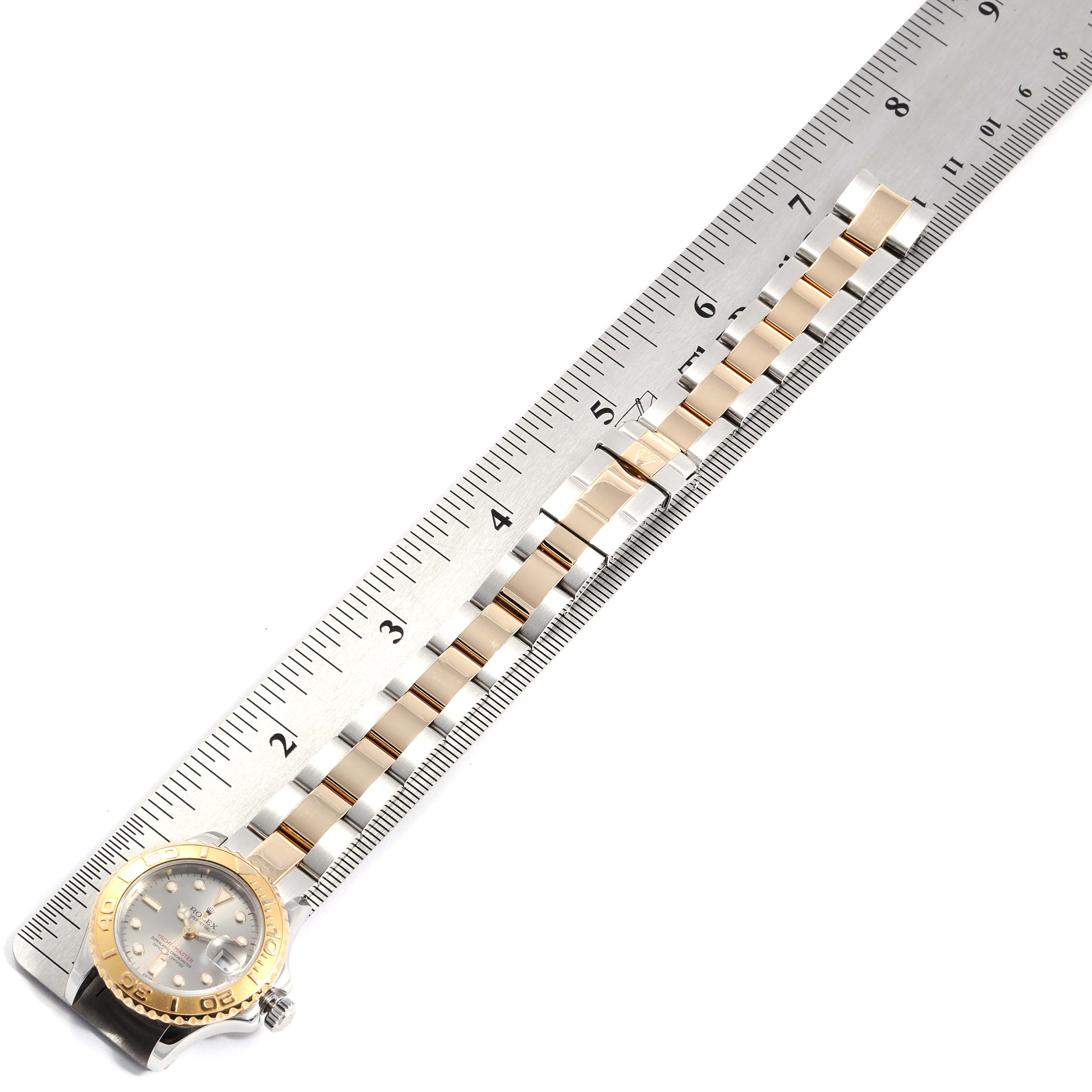 The image shows the bracelet and face of the Rolex Yacht-Master 169623 Women's Steel and Gold (two tone) Grey Dial 169623 Women's Steel and Gold (two tone) Grey Dial watch alongside a ruler for measurement.