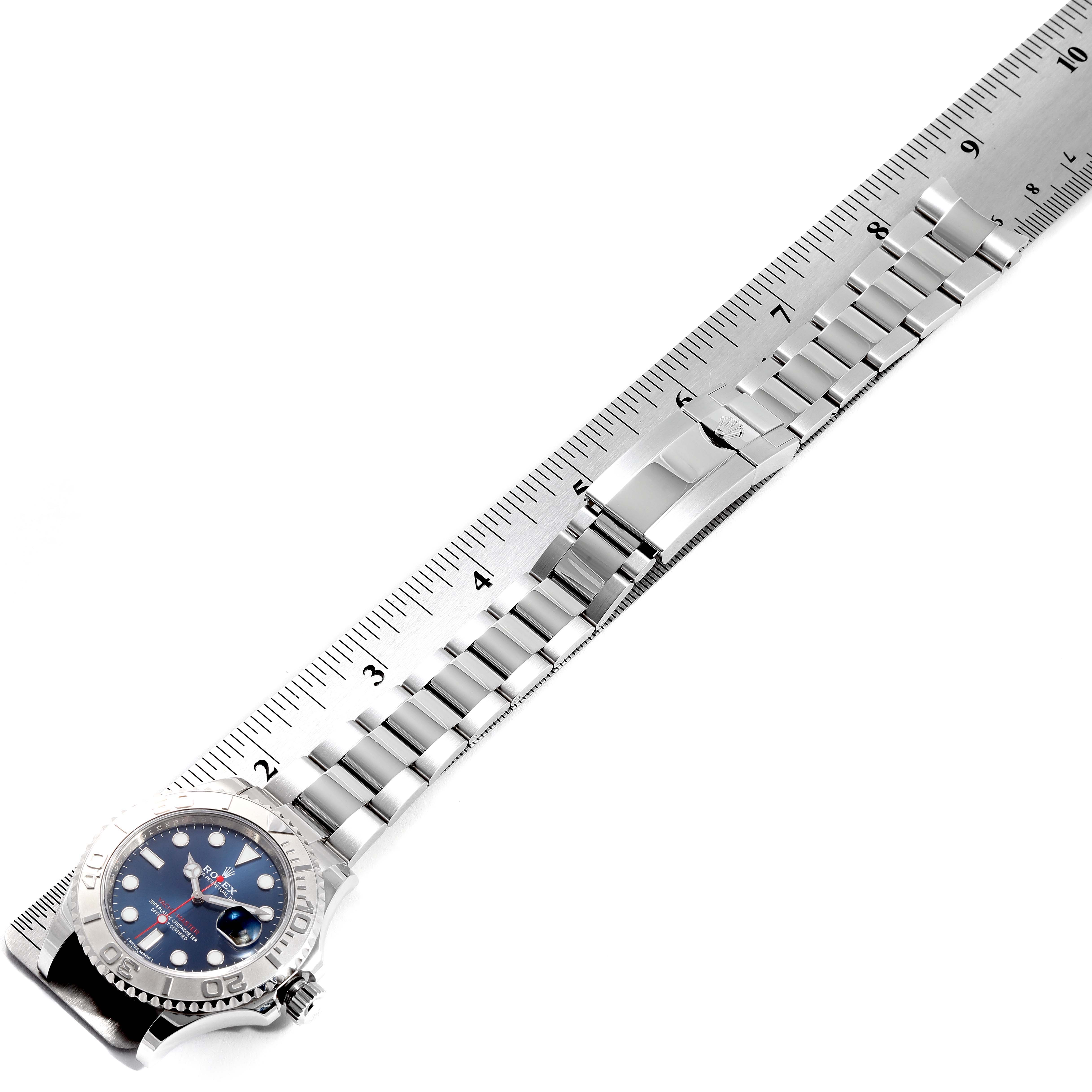 The image shows a Rolex Yacht-Master 116622 Men
s Stainless Steel Blue Dial 116622 Men
s Stainless Steel Blue Dial watch laid flat with its bracelet fully extended alongside a measuring ruler.