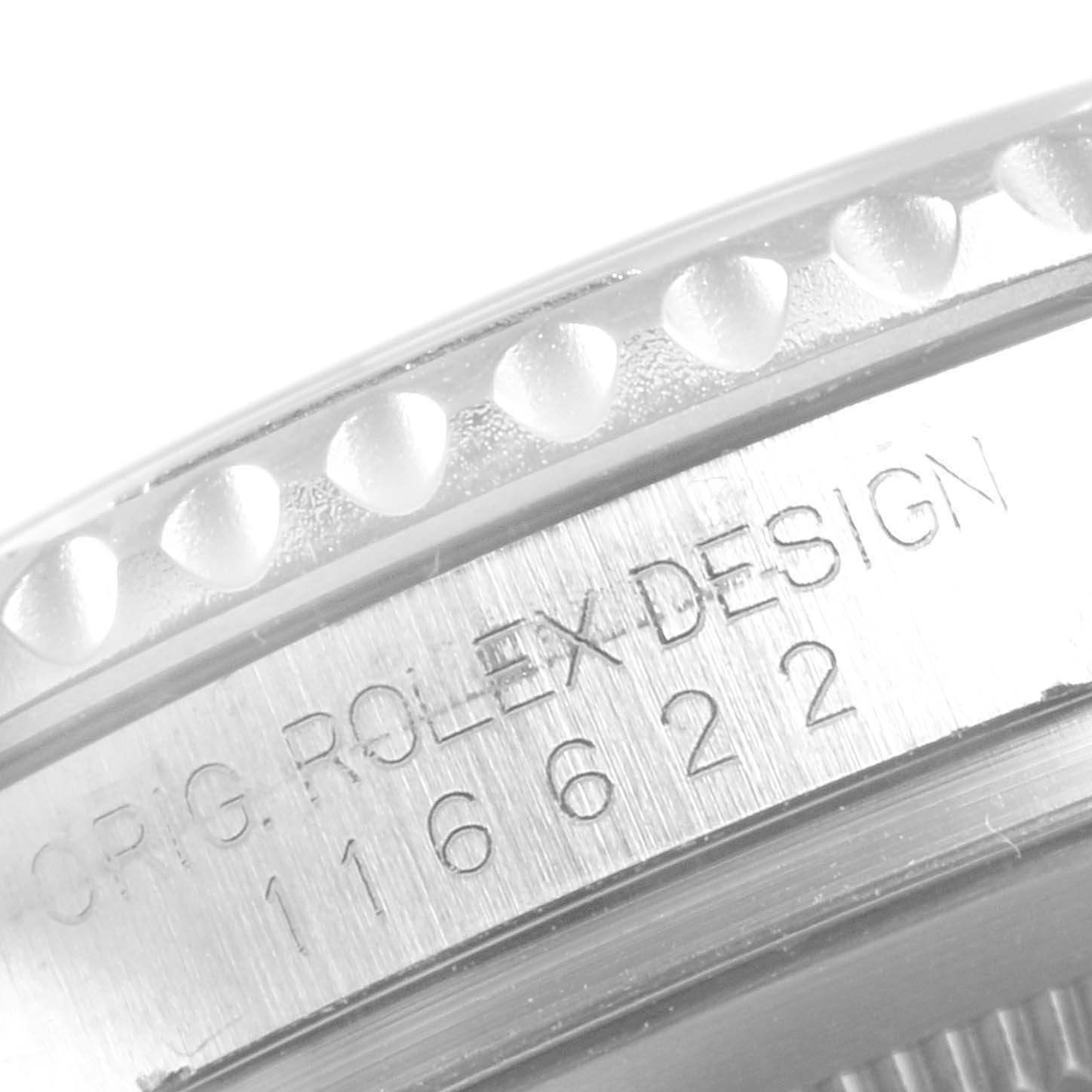The image shows a close-up of the bezel and engraved serial number on the Yacht-Master model by Rolex.