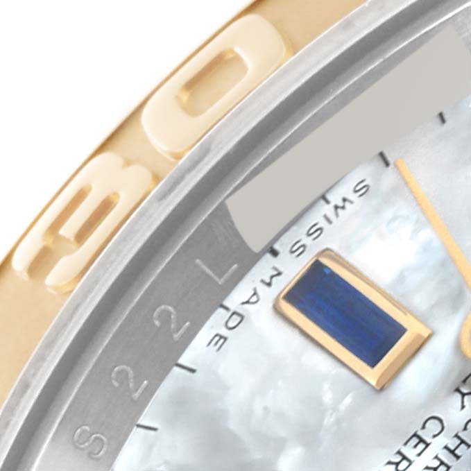 This close-up image of the Yacht-Master by Rolex shows the bezel, part of the dial, and a portion of an hour marker.