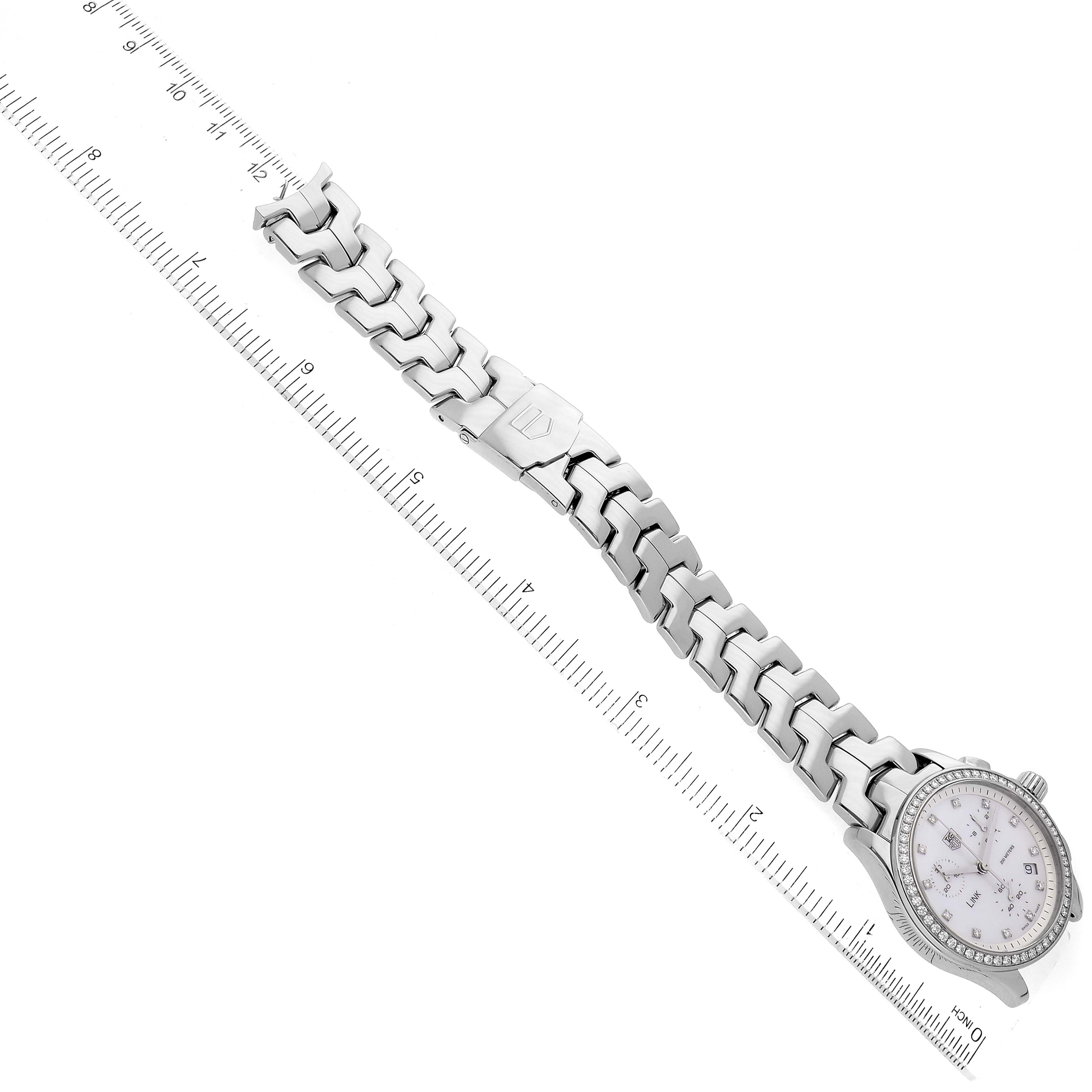 The image shows the Tag Heuer Link CJF1314 Women's Stainless Steel Mother of Pearl Dial CJF1314 Women's Stainless Steel Mother of Pearl Dial watch laid flat with a ruler measuring the length of its stainless steel bracelet.