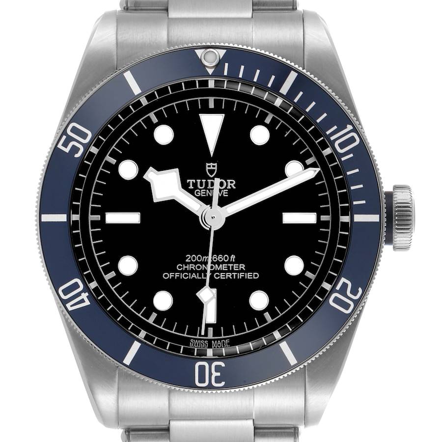 The Tudor Heritage Black Bay is shown from a front angle, displaying the dial, bezel, and crown.