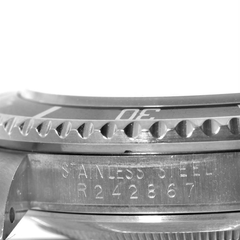 Close-up view of a Rolex Submariner 168000 Men
s Stainless Steel Black Dial 168000 Men
s Stainless Steel Black Dial showing the stainless steel casing, bezel, and part of the engraved serial number.