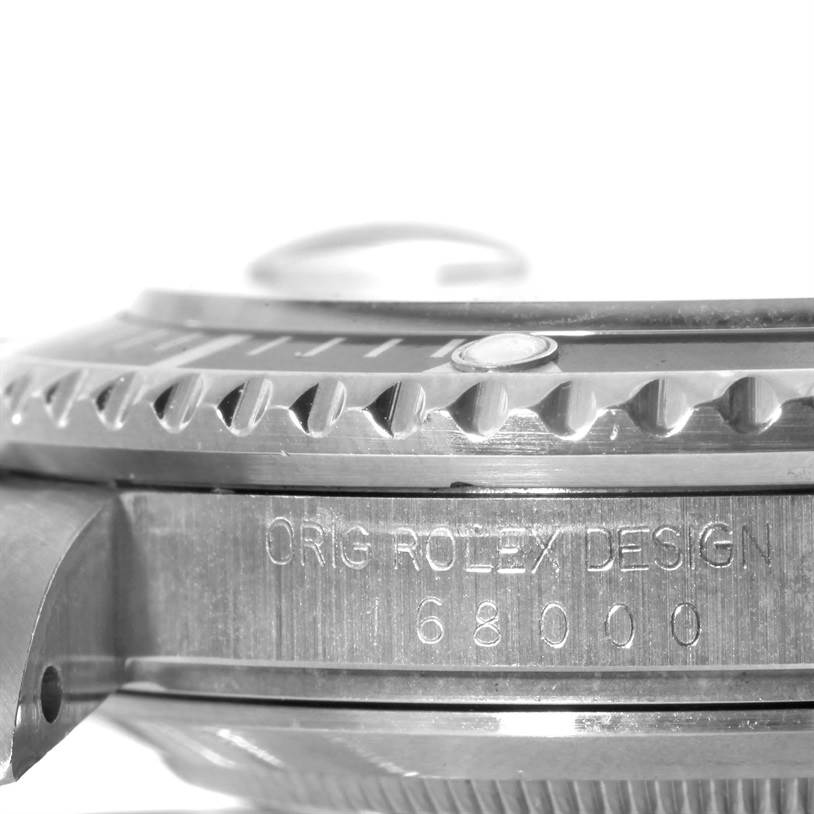 The image shows a close-up side angle of a Rolex Submariner 168000 Men
s Stainless Steel Black Dial 168000 Men
s Stainless Steel Black Dial watch, focusing on the bezel and engraved model number.