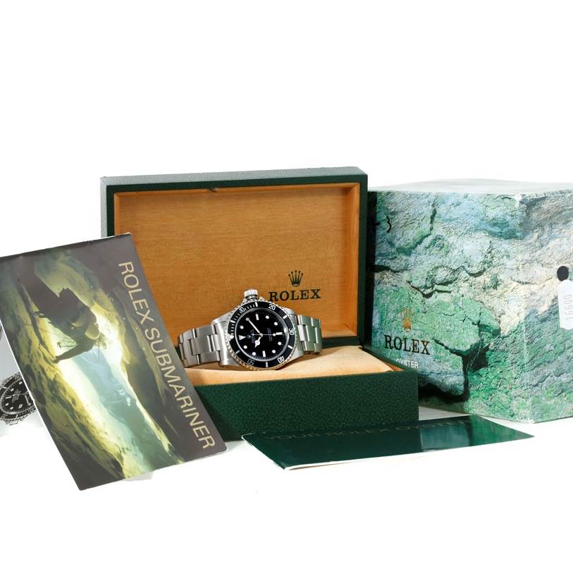 The image shows a Rolex Submariner 14060 Men
s Stainless Steel Black Dial 14060 Men
s Stainless Steel Black Dial watch positioned inside its branded box with accompanying manual and outer packaging.