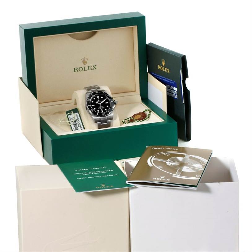 The Rolex Submariner 114060 Men
s Stainless Steel Black Dial 114060 Men
s Stainless Steel Black Dial watch is shown front-facing in its display case, along with its box, booklets, and tags.