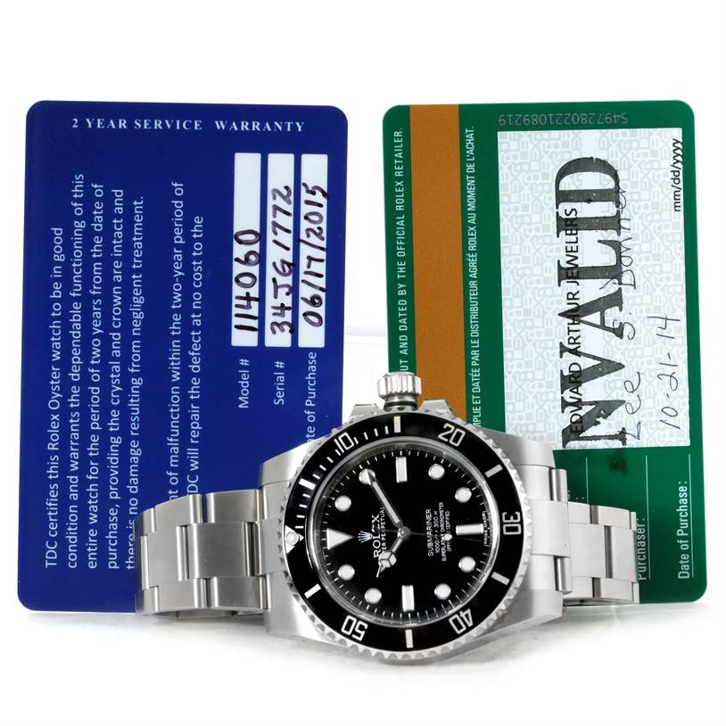 The image shows a Rolex Submariner 114060 Men
s Stainless Steel Black Dial 114060 Men
s Stainless Steel Black Dial watch and two warranty cards from a front angle.