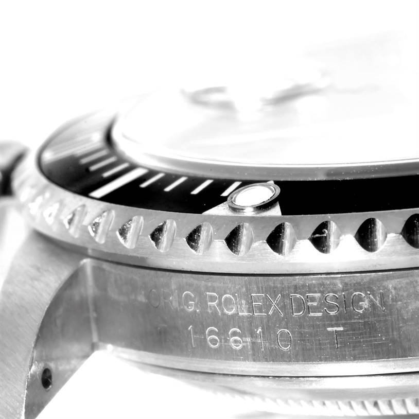 The image shows a close-up side angle of the bezel and engraved side of a Rolex Submariner 16610 Men
s Stainless Steel Black Dial 16610 Men
s Stainless Steel Black Dial watch.