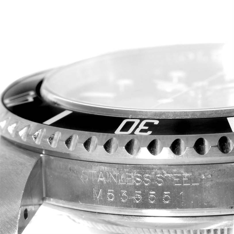 This close-up image of the Rolex Submariner 16610 Men
s Stainless Steel Black Dial 16610 Men
s Stainless Steel Black Dial watch highlights its bezel edge and stainless steel case side with engraved text.