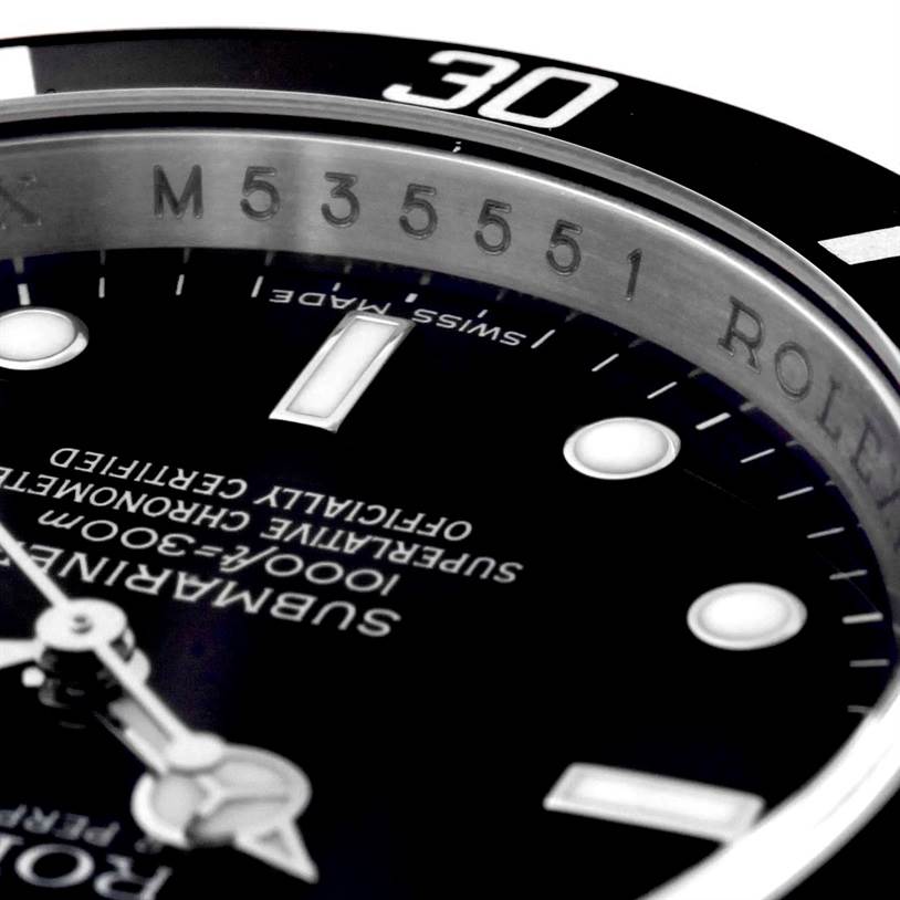 This close-up image of a Rolex Submariner 16610 Men
s Stainless Steel Black Dial 16610 Men
s Stainless Steel Black Dial shows parts of the dial, hands, and bezel from an angled side view.