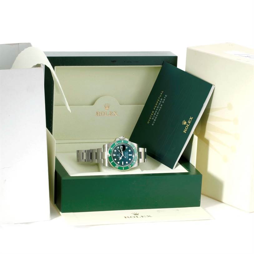 The image shows a Rolex Submariner 116610LV Men's Stainless Steel Green Dial 116610LV Men's Stainless Steel Green Dial watch in its open box, accompanied by its green booklet and packaging materials.