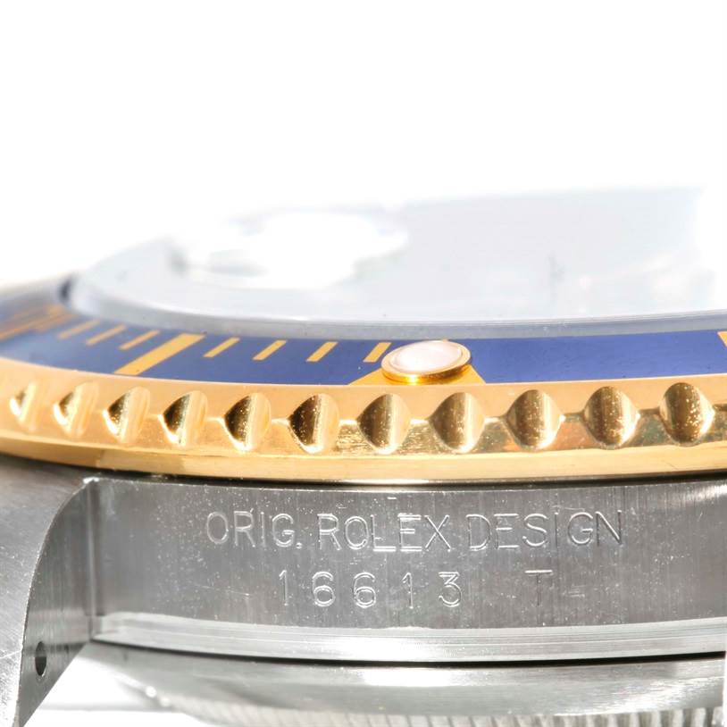 This close-up angle shows the engraved side and bezel of the Rolex Submariner 16613 Men
s Steel and Gold (two tone) Blue Dial 16613 Men
s Steel and Gold (two tone) Blue Dial model.