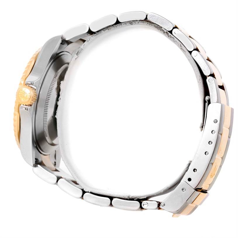 The image shows a side view of a Rolex Submariner 16613 Men
s Steel and Gold (two tone) Blue Dial 16613 Men
s Steel and Gold (two tone) Blue Dial, highlighting the bracelet, clasp, and the watch crown.