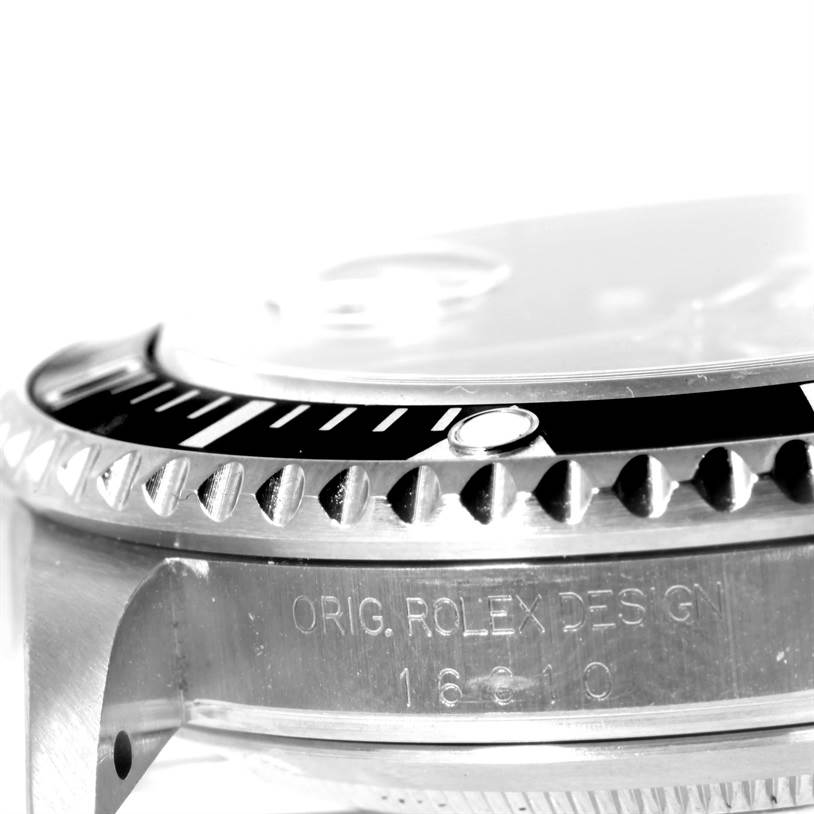 This close-up image shows the side bezel and case inscription of a Rolex Submariner 16610 Men
s Stainless Steel Black Dial 16610 Men
s Stainless Steel Black Dial watch.