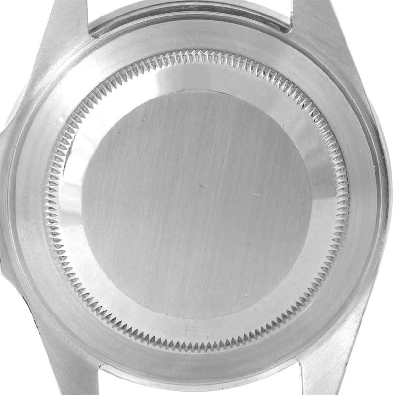 This image shows the back case of a Rolex Submariner 16610 Men
s Stainless Steel Black Dial 16610 Men
s Stainless Steel Black Dial watch, viewed from a top-down angle.