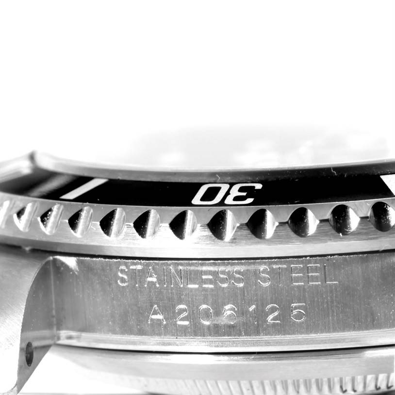 The image shows a close-up side view of the bezel and case of the Rolex Submariner 16610 Men
s Stainless Steel Black Dial 16610 Men
s Stainless Steel Black Dial watch, highlighting the "Stainless Steel" engraving.