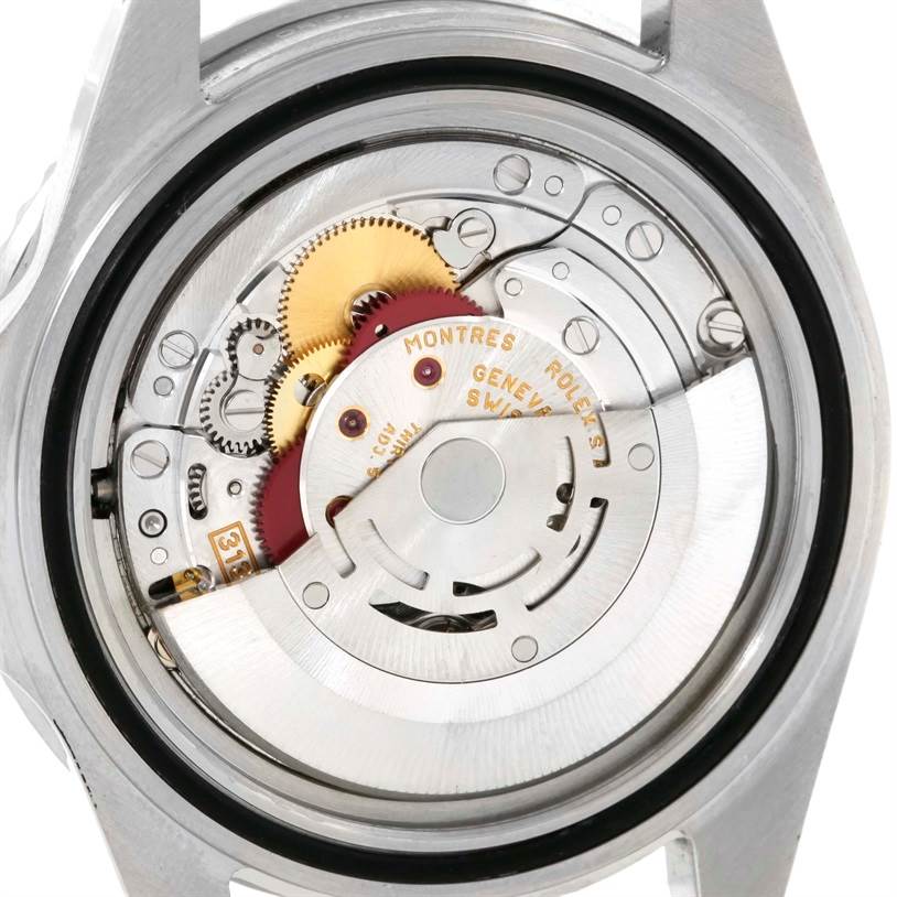 The image shows a close-up of the movement and inner mechanisms of a Rolex Submariner 16610 Men
s Stainless Steel Black Dial 16610 Men
s Stainless Steel Black Dial watch from a rear view angle.