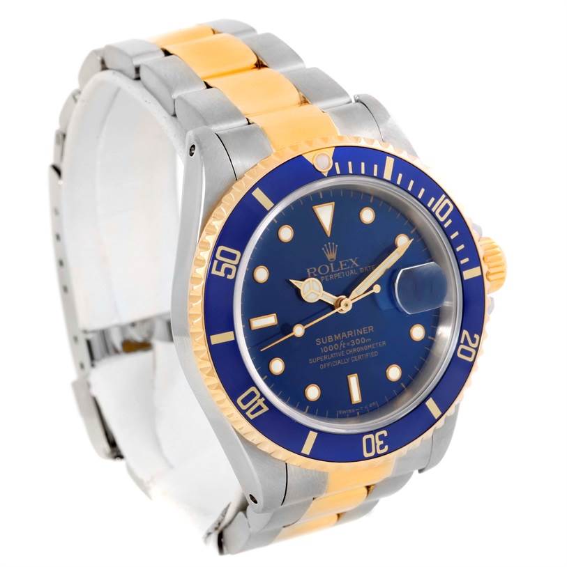 The image shows a Rolex Submariner 16613 Men's Steel and Gold (two tone) Blue Dial 16613 Men's Steel and Gold (two tone) Blue Dial watch at a slight angle, highlighting the face, bezel, and two-tone strap.