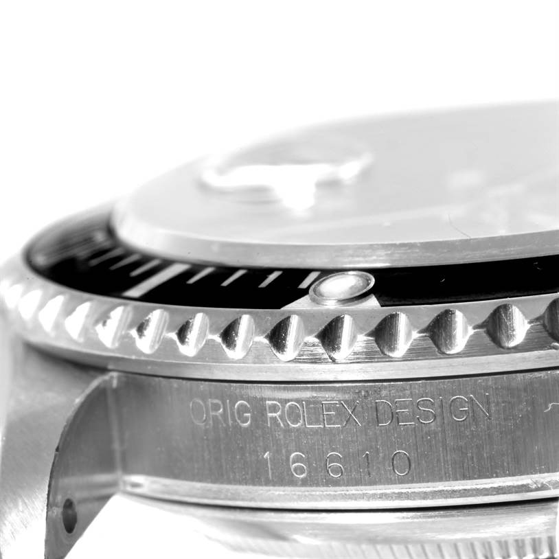 The image shows a close-up side view of the watch bezel and case of a Rolex Submariner 16610 Men
s Stainless Steel Black Dial 16610 Men
s Stainless Steel Black Dial, model 16610.