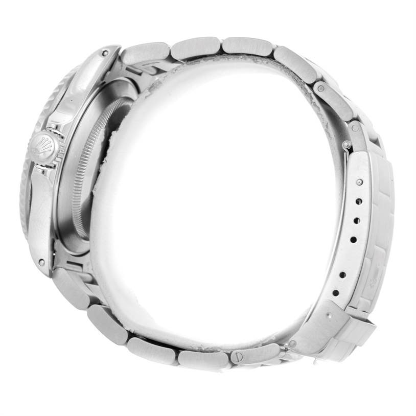 This side view of a Rolex Submariner 16610 Men
s Stainless Steel Black Dial 16610 Men
s Stainless Steel Black Dial shows the case, crown, and a portion of the bracelet with clasp.