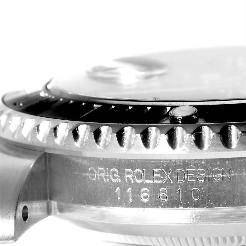 This macro shot of a Rolex Submariner 116610 Men
s Stainless Steel Black Dial 116610 Men
s Stainless Steel Black Dial shows the watch
s case, bezel, and model number engraving.
