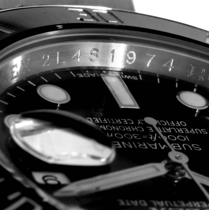 This close-up image of a Rolex Submariner 116610 Men
s Stainless Steel Black Dial 116610 Men
s Stainless Steel Black Dial shows the dial, a portion of the bezel, and the cyclops lens magnifying the date.