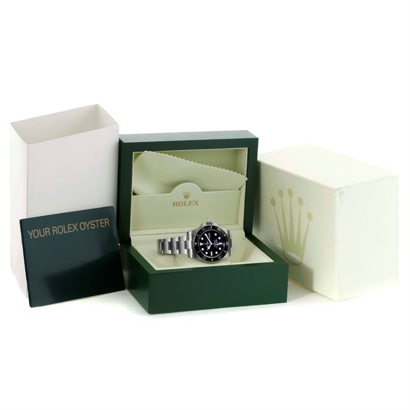 The image shows a Rolex Submariner 116610 Men
s Stainless Steel Black Dial 116610 Men
s Stainless Steel Black Dial watch displayed in an open green Rolex box with accompanying packaging and booklet.