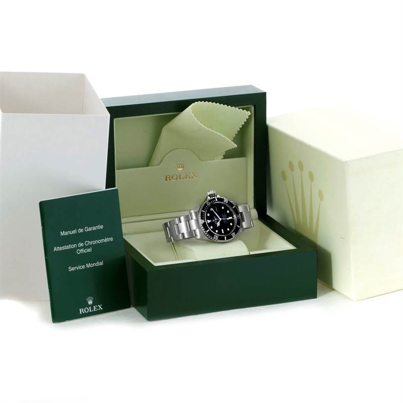 The image shows a Rolex Submariner 16610 Men
s Stainless Steel Black Dial 16610 Men
s Stainless Steel Black Dial watch inside its box, along with the warranty manual and packaging.