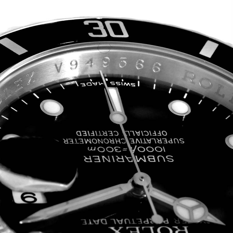 This image shows a close-up of the Rolex Submariner 16610 Men
s Stainless Steel Black Dial 16610 Men
s Stainless Steel Black Dial watch face, bezel, and serial number engraving.