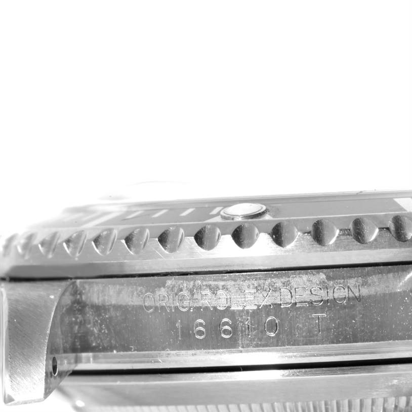 The image shows a side view of the Rolex Submariner 16610 Men
s Stainless Steel Black Dial 16610 Men
s Stainless Steel Black Dial watch, highlighting the bezel, case, and engraved model number 16610 T.