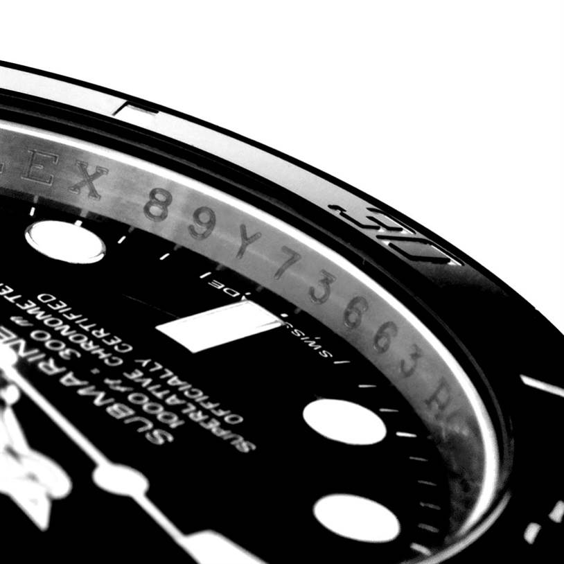 Close-up angled shot of the Rolex Submariner 116610 Men
s Stainless Steel Black Dial 116610 Men
s Stainless Steel Black Dial, showing part of the bezel with engraved numbers and partial view of the dial text.
