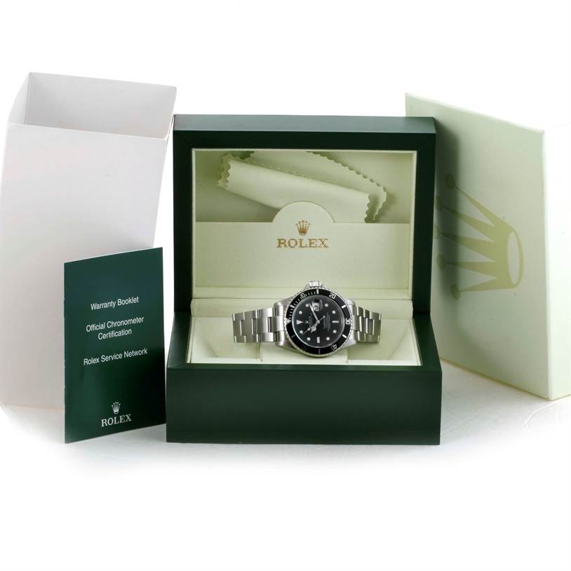 The image shows a Rolex Submariner 16610 Men
s Stainless Steel Black Dial 16610 Men
s Stainless Steel Black Dial watch displayed in its box along with the warranty booklet and certification papers.