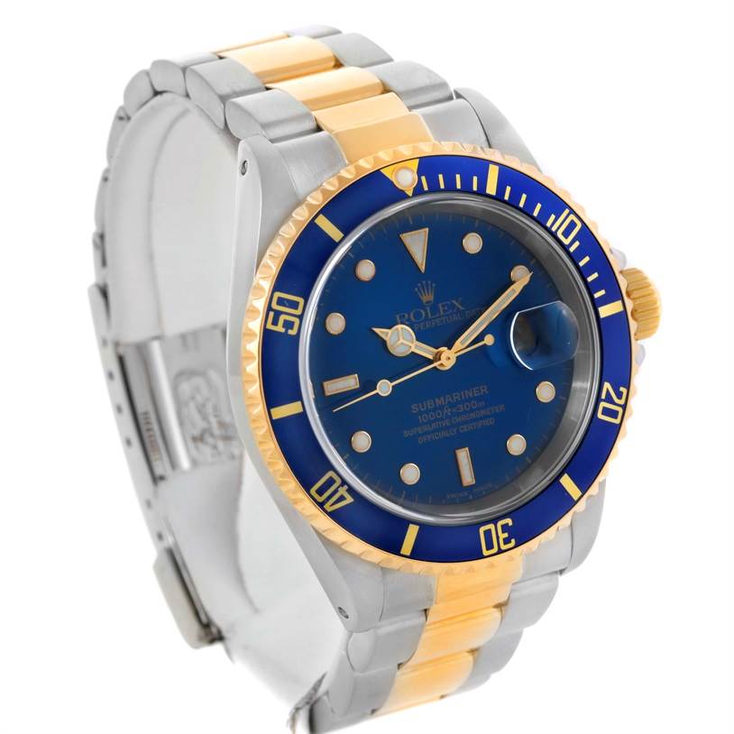 The image shows a Rolex Submariner 16613 Men's Steel and Gold (two tone) Blue Dial 16613 Men's Steel and Gold (two tone) Blue Dial watch at a three-quarter angle, highlighting its blue dial, bezel, and two-tone metal strap.