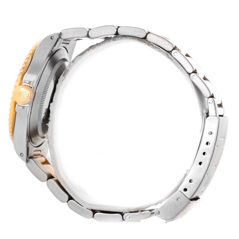 The image shows a side profile of a Rolex Submariner 16613 Men's Steel and Gold (two tone) Blue Dial 16613 Men's Steel and Gold (two tone) Blue Dial, highlighting its case, bezel, crown, and metal strap.