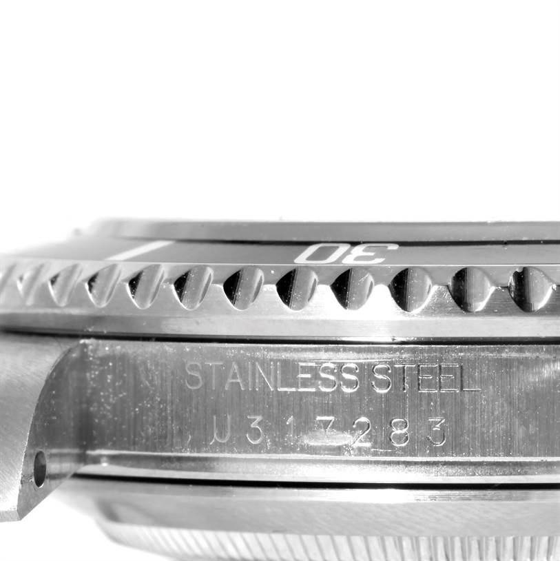 This image shows a side view of a Rolex Submariner 16610 Men
s Stainless Steel Black Dial 16610 Men
s Stainless Steel Black Dial
s case, specifically highlighting the bezel and engraving.